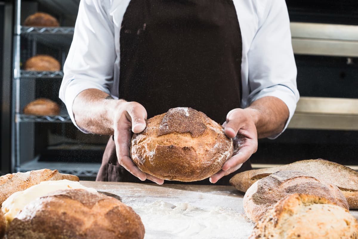 Baker shaping fresh sourdough bread